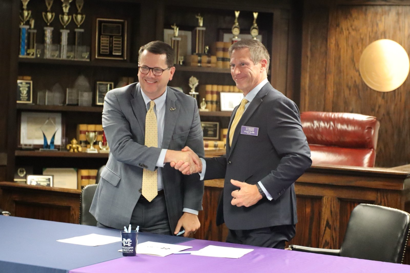MC President Blake Thompson and Millsaps President Frank Neville shake hands after signing the 3+3 agreement